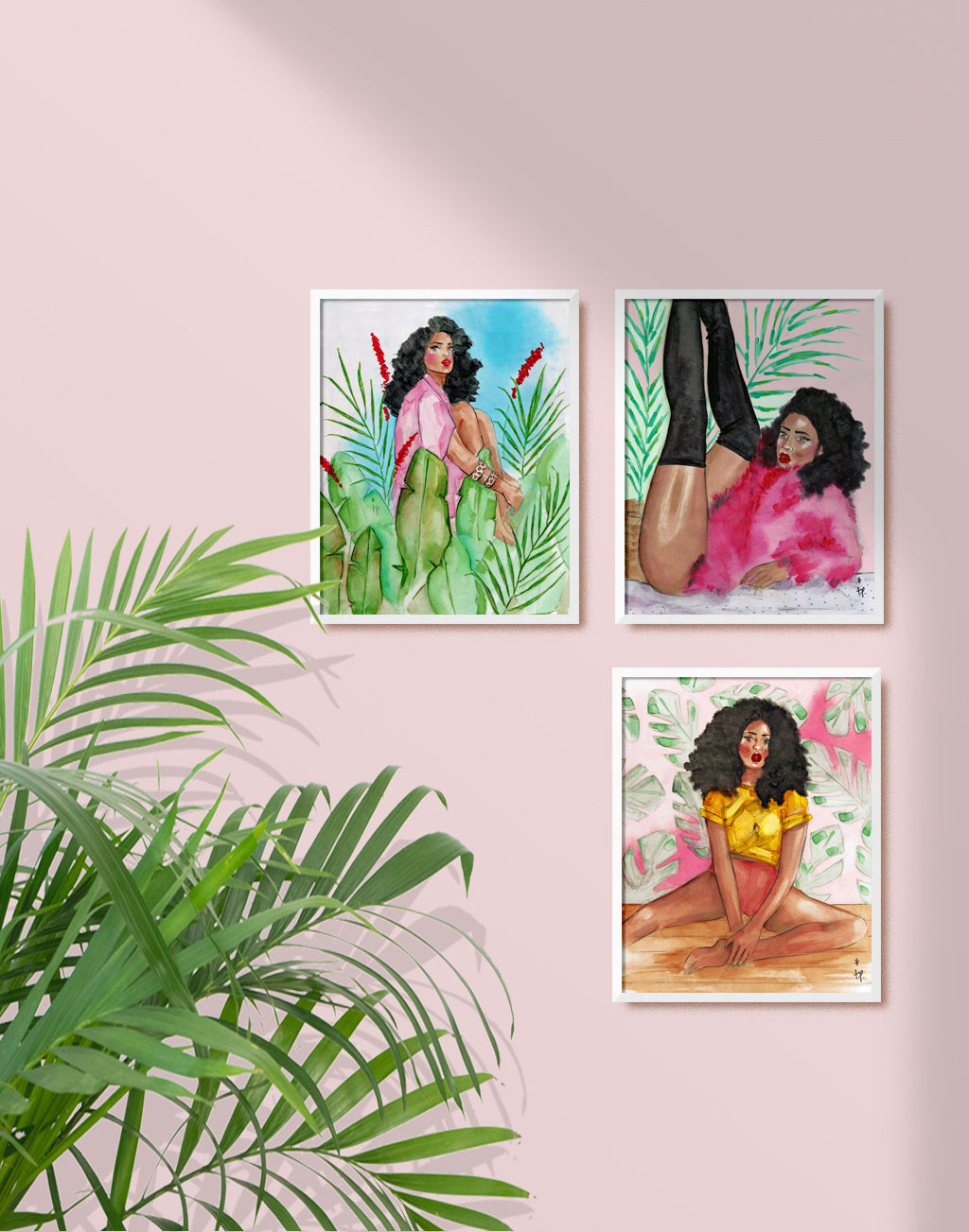 Framed illustration of a woman with curly hair wearing a pink shirt and sitting with her knees to her chest amongst tropical flowers and plants by Tatiana Poblah