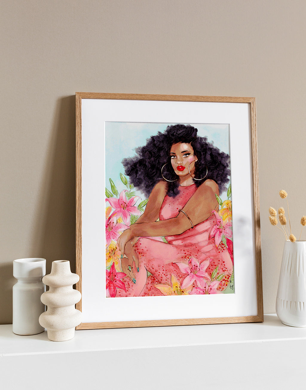 Illustration in a light frame of a beautiful curvy woman wearing a coral jumpsuit and sitting in a valley of lilies by Tatiana Poblah