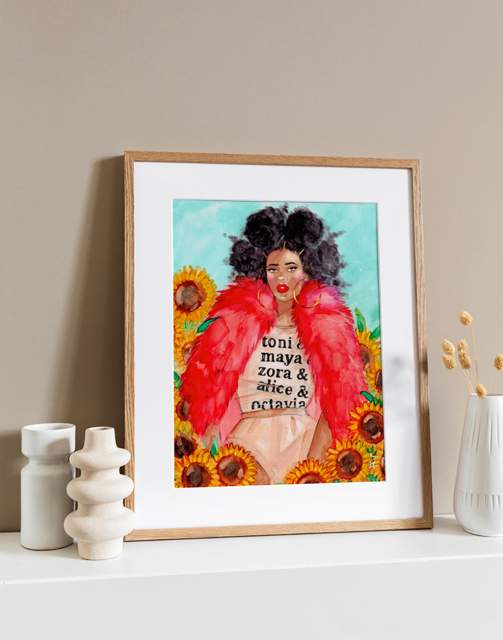 Illustration in a light frame of a beautiful black woman wearing a red fur and a toni morrisson tee sitting amongst sunflowers by Tatiana Poblah