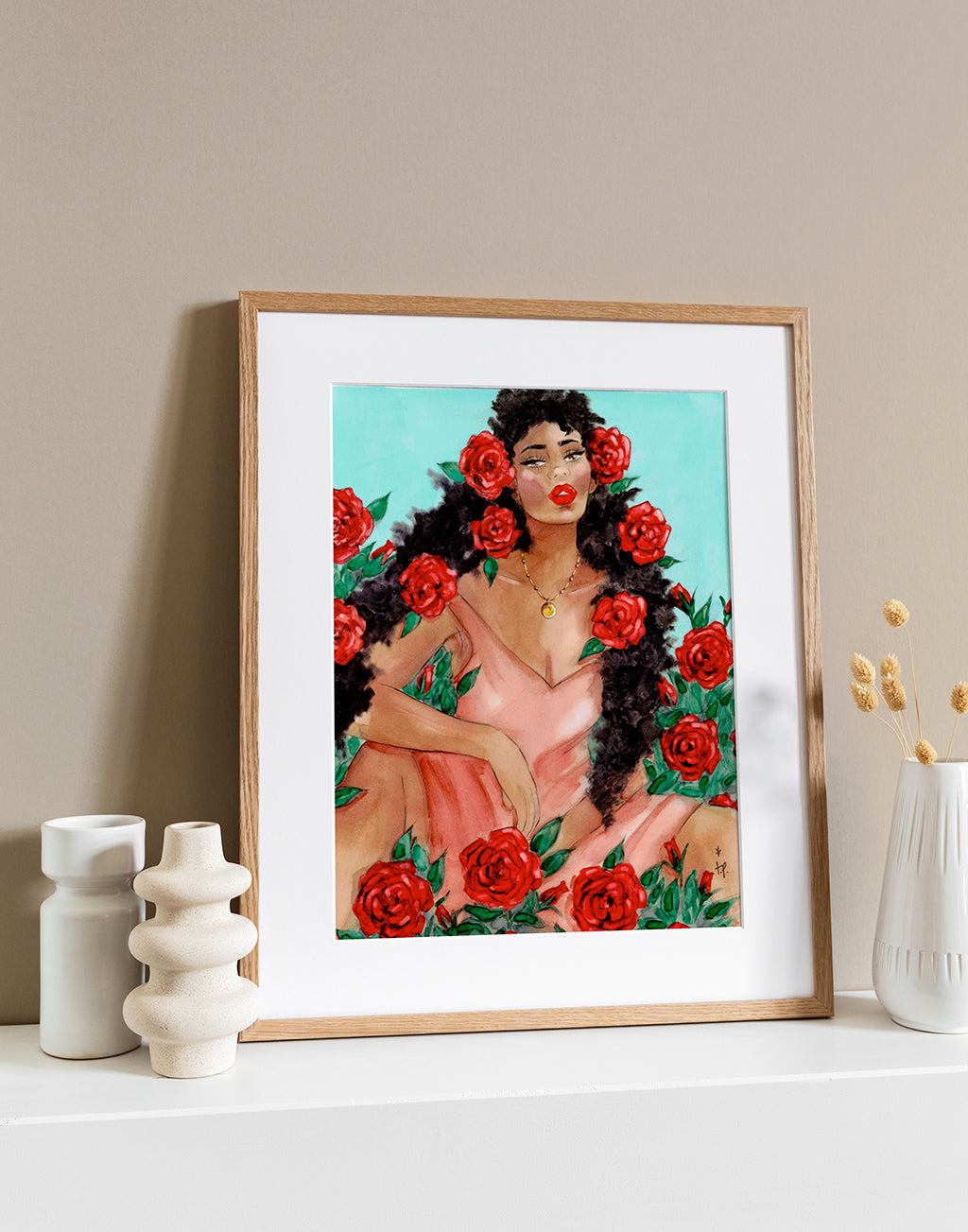Illustration in a light frame of a gorgeous woman with red roses in her hair sitting in a bush of red roses by Tatiana Poblah